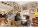 Cozy living room with hardwood flooring and staircase with wrought iron detail at 3510 Estates Landing Nw Dr, Kennesaw, GA 30144