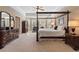 Spacious main bedroom featuring a tray ceiling, bay window, and elegant four-poster bed at 3510 Estates Landing Nw Dr, Kennesaw, GA 30144