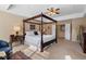 Spacious main bedroom featuring a tray ceiling, furniture, and elegant four-poster bed at 3510 Estates Landing Nw Dr, Kennesaw, GA 30144