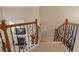 Carpeted staircase with decorative wrought iron and wood railing leads to the home's second level at 3510 Estates Landing Nw Dr, Kennesaw, GA 30144