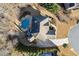 Aerial view of a beautiful home with a private backyard pool, lush landscaping, and a well-maintained roof at 5245 Wilshire Xing, Cumming, GA 30040