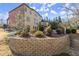 Landscaped backyard featuring a retaining wall, lush greenery, and a well-manicured lawn for outdoor enjoyment at 5245 Wilshire Xing, Cumming, GA 30040