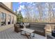 Relaxing outdoor deck area with wicker furniture, offering a serene space for lounging and entertaining at 5245 Wilshire Xing, Cumming, GA 30040