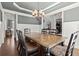 Formal dining room with hardwood floors, wainscoting and elegant chandelier at 5245 Wilshire Xing, Cumming, GA 30040