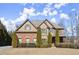 Stately two-story home showcasing a blend of brick and siding, complemented by manicured shrubs and a well-maintained lawn at 5245 Wilshire Xing, Cumming, GA 30040