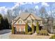 Beautiful two-story home featuring a brick and siding exterior with manicured landscaping and a charming front entrance at 5245 Wilshire Xing, Cumming, GA 30040