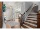 Elegant foyer featuring hardwood floors, stairs, and views into the dining room at 5245 Wilshire Xing, Cumming, GA 30040