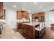 Kitchen with an island, stainless steel appliances, and wooden cabinets at 5245 Wilshire Xing, Cumming, GA 30040