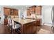 Kitchen featuring a large island, granite counters, stainless appliances, and wooden cabinets at 5245 Wilshire Xing, Cumming, GA 30040