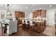 A spacious kitchen with dark wood cabinets, an island, a breakfast table and chairs at 5245 Wilshire Xing, Cumming, GA 30040