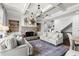 Open-concept living room with fireplace, built-in shelving, and coffered ceiling at 5245 Wilshire Xing, Cumming, GA 30040