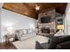 Spacious living room features a stone fireplace, wood ceiling and large windows to the backyard at 5245 Wilshire Xing, Cumming, GA 30040