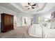 Spacious main bedroom boasts trey ceiling, ceiling fan, and an abundance of natural light at 5245 Wilshire Xing, Cumming, GA 30040