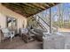 Cozy covered patio with lounge furniture, offering a relaxing outdoor space beneath wooden beams at 5245 Wilshire Xing, Cumming, GA 30040