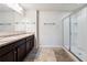 Bathroom featuring double vanity, framed mirror, ceramic tile flooring, and glass-enclosed shower at 110 Centennial Ridge Dr, Acworth, GA 30102