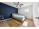 Bedroom featuring a dark blue accent wall, ceiling fan, and a window at 110 Centennial Ridge Dr, Acworth, GA 30102