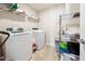 Functional laundry room with modern washer, dryer, and organized shelving at 110 Centennial Ridge Dr, Acworth, GA 30102