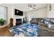 Comfortable living room with a fireplace, ceiling fan, and a plush leather sofa at 110 Centennial Ridge Dr, Acworth, GA 30102