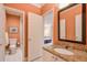 Bathroom featuring a granite countertop, framed mirror, and adjoining toilet and shower at 2318 Edgemere Lake Cir, Marietta, GA 30062