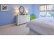 Bright bedroom showcasing a white dresser, green chair, and sunny window at 2318 Edgemere Lake Cir, Marietta, GA 30062