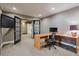 This carpeted office features grey walls, black french doors, and a light-colored desk with black office chair at 2318 Edgemere Lake Cir, Marietta, GA 30062