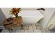 Modern white soaking tub is paired with a dark faucet and wooden side table at 29 Macedonia Rd, White, GA 30184