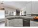 Well-lit kitchen featuring white cabinets, dark countertops, and stainless steel appliances at 845 Johnson Mill Ter, Sugar Hill, GA 30518