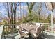 Enjoy outdoor dining on this spacious back deck with a table and chairs set amidst the trees at 144 Murray Hill Ne Ave, Atlanta, GA 30317