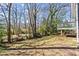 Backyard view featuring lush greenery, mature trees and a glimpse of the home's back deck at 144 Murray Hill Ne Ave, Atlanta, GA 30317