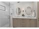 Modern bathroom with a walk-in shower, double sinks, and vanity with quartz countertops at 144 Murray Hill Ne Ave, Atlanta, GA 30317