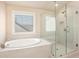 Bright bathroom featuring a soaking tub and glass-enclosed shower at 2435 Portsmouth Ct, Marietta, GA 30064