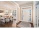 Inviting foyer with hardwood floors and a view into the dining room featuring a chandelier and natural light at 2435 Portsmouth Ct, Marietta, GA 30064