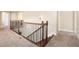 Upstairs hallway featuring a staircase with wood and iron railing, and neutral colored carpet at 2435 Portsmouth Ct, Marietta, GA 30064