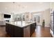 Open-concept kitchen with a large island, stainless steel appliances, and seamless flow into the living room at 2435 Portsmouth Ct, Marietta, GA 30064