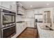 Modern kitchen featuring white cabinets, granite counters and stainless steel appliances at 2435 Portsmouth Ct, Marietta, GA 30064