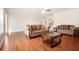 Bright living room features hardwood floors, ceiling fan, and traditional-style sofas at 2435 Portsmouth Ct, Marietta, GA 30064