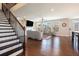 Spacious living room featuring hardwood floors, a staircase, fireplace and large windows for natural light at 2435 Portsmouth Ct, Marietta, GA 30064