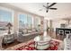 Living room featuring large windows providing natural light, a ceiling fan, and open access to the kitchen at 2435 Portsmouth Ct, Marietta, GA 30064