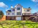 Exterior of the home with a deck, garage, and sprawling green backyard at 2925 Chesterfield Se Way, Conyers, GA 30013