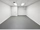 Finished basement space with clean, painted floor and a single door at 2925 Chesterfield Se Way, Conyers, GA 30013