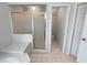 Bathroom showing walk-in shower with bench and glass door at 2925 Chesterfield Se Way, Conyers, GA 30013