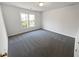 Bedroom featuring gray carpet, neutral walls, a window, and white door at 2925 Chesterfield Se Way, Conyers, GA 30013