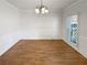 Traditional dining room with hardwood floors, chandelier, and wainscoting at 2925 Chesterfield Se Way, Conyers, GA 30013