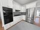 Modern kitchen with white cabinets, stainless steel appliances, and sleek countertops at 2925 Chesterfield Se Way, Conyers, GA 30013