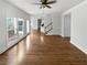 Open living room featuring hardwood floors, a ceiling fan, and natural light at 2925 Chesterfield Se Way, Conyers, GA 30013