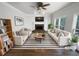 Bright living room featuring a fireplace, hardwood floors, and neutral furniture at 2925 Chesterfield Se Way, Conyers, GA 30013