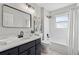 This full bathroom features updated fixtures, an ornate mirror, and modern shower and bathtub at 4035 Chelsea Cmn, Tucker, GA 30084