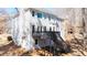 Backyard exterior view of a two-story house with a deck and stair access at 724 Eastwood Rise, Stone Mountain, GA 30087