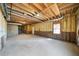 Unfinished basement with insulated walls, concrete floors, and exposed ceiling at 724 Eastwood Rise, Stone Mountain, GA 30087