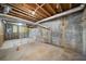 Unfinished basement with exposed wooden ceiling beams and a concrete floor at 724 Eastwood Rise, Stone Mountain, GA 30087